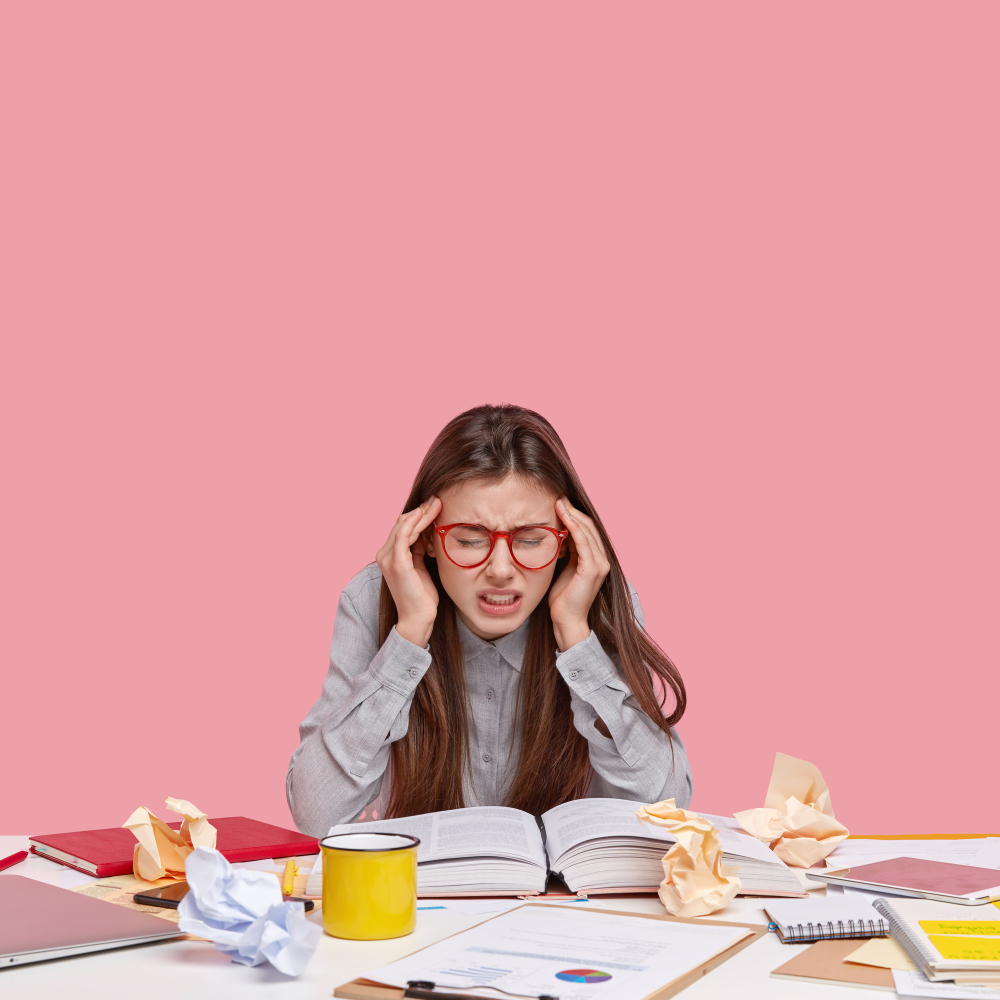 student sitting desk with documents